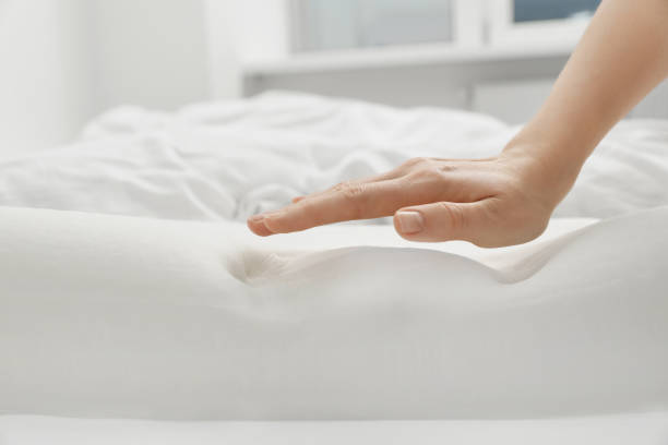 istock Woman with orthopedic memory foam pillow on bed, closeup. Space for text 1786618428