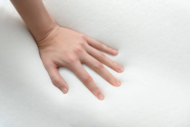 istock Woman touching orthopedic memory foam pillow on white background, closeup 1786618938