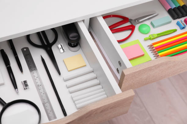 istock Office supplies in open desk drawers, above view 1786620551