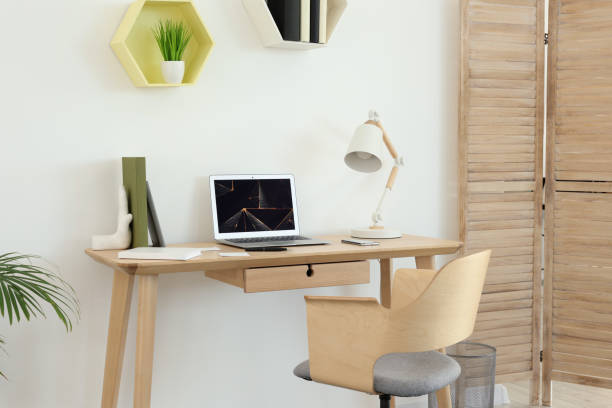 istock Cozy workspace with modern laptop on desk and comfortable chair at home 1786621061
