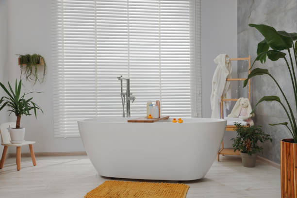 istock Stylish bathroom interior with beautiful tub and decor elements 1786623644