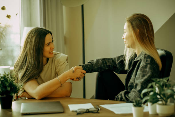 istock Two young female colleagues drink coffee in the office and discuss work 1786626826