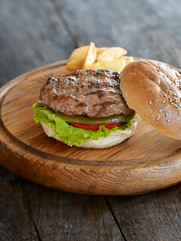 Delicious hamburger serving on a wooden table top