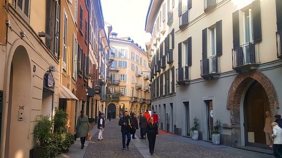 Milan, Italy - 17 March 2015 : people walking in a small historic italian elegant shopping street