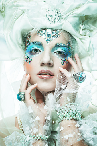 Party, christmas and people concept: Young woman with blue artistic make-up. Winter Portrait. Snow Queen.