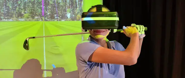Photo of Golfer in virtual glasses plays golf closeup