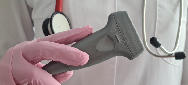 Doctor prepares ultrasound machine for diagnosing patient. Doctor holding an ultrasound probe of internal organs