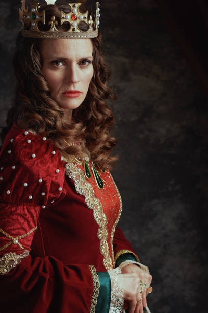 istock medieval queen in red dress with crown 1786729379