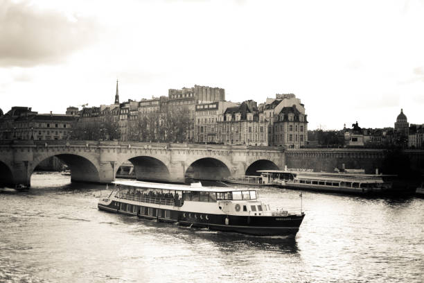 Paris, France: A river cruise on the Seine River run by Bateaux Parisiens; the bridge in the background is the Pont Neuf.