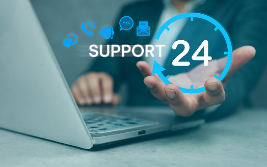 Businessman holding virtual 24 support service icons. Guarantee 24 hour and 7 days per week full-time available contact. Assistance customer service concept. Customer support hotline. Contact us