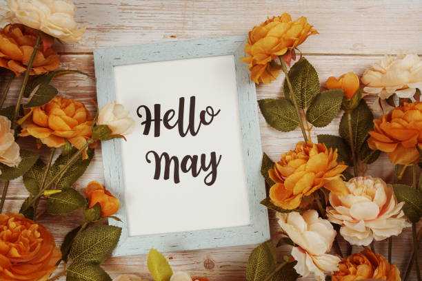 istock Hello May typography text with flower decoation on wooden background 1787012993