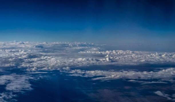 istock Aerial View above clouds in the Sky from an Airplane 1787015994
