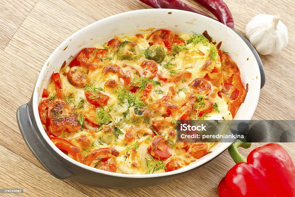 vegetables baked with cheese different vegetables baked with cheese in the oven Baked Stock Photo