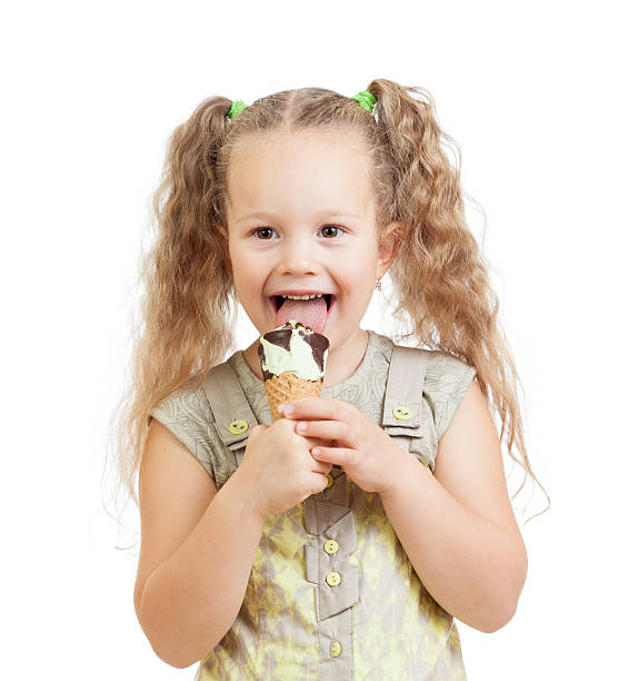 istock little curly girl eating ice cream in studio 178702881