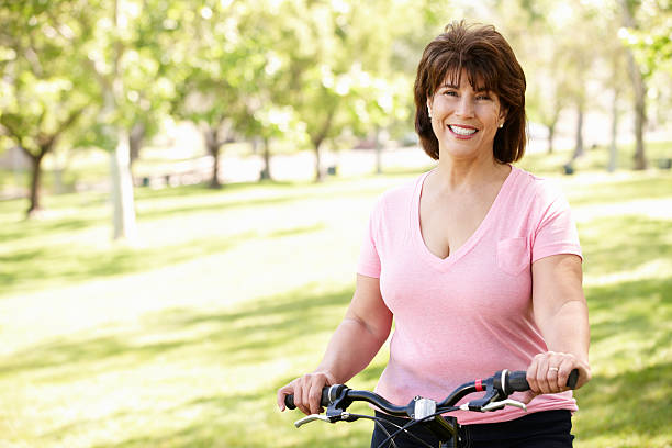 istock Senior Hispanic woman with bike 178703180