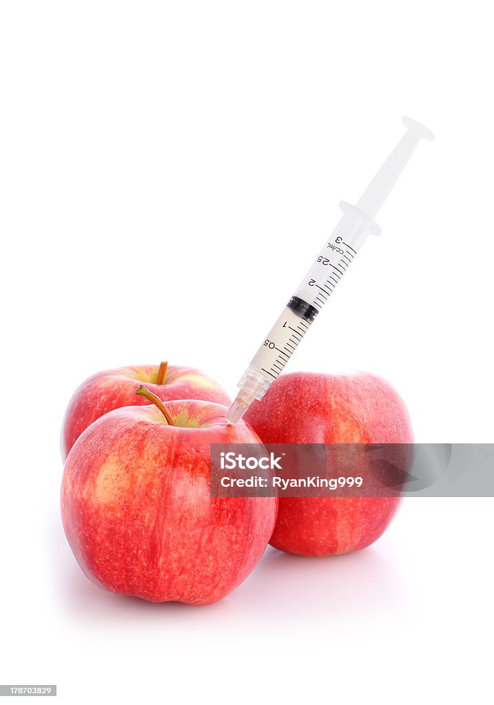 Apple with Needle Apple with Needle isolated on white background Agriculture Stock Photo