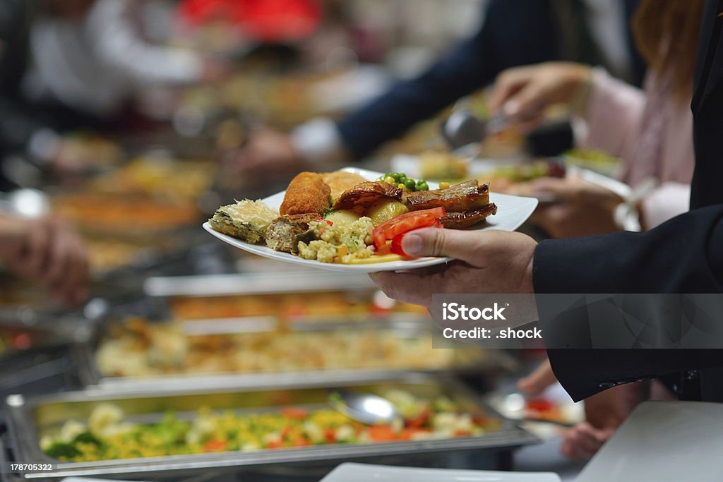 People in a buffet line with full plates people group catering buffet food indoor in luxury restaurant with meat colorful fruits  and vegetables Buffet Stock Photo
