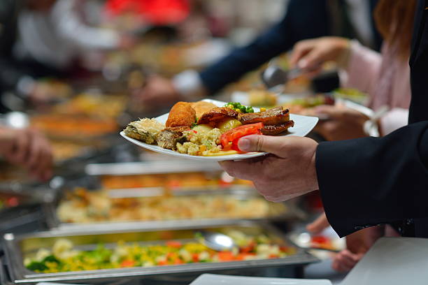 People in a buffet line with full plates people group catering buffet food indoor in luxury restaurant with meat colorful fruits  and vegetables cooking class photos stock pictures, royalty-free photos & images