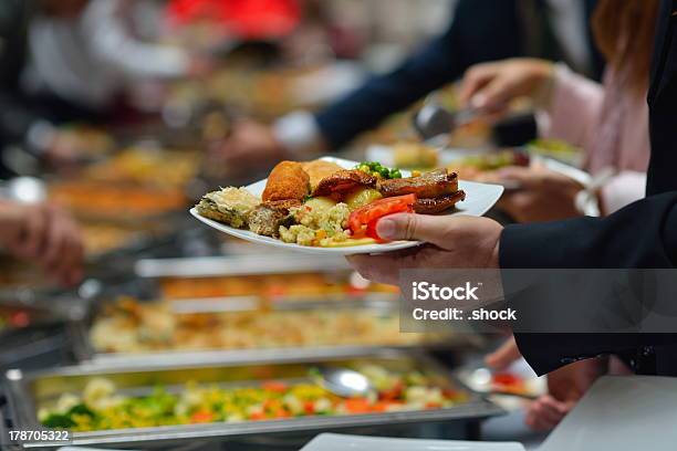 People In A Buffet Line With Full Plates Stock Photo - Download Image Now - Buffet, Food, Lunch