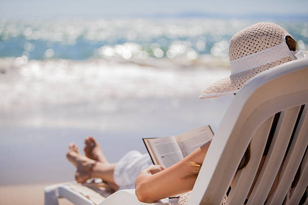 istock Relaxing and reading at the beach 178705700