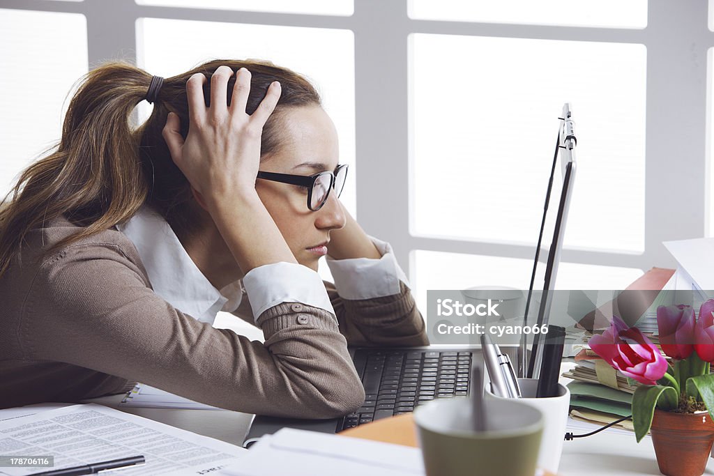 Frustated businesswoman Young and beautiful businesswoman tired from work in the office.Woman holding her head People Stock Photo