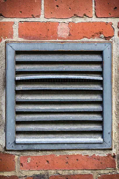 outdoor ventilation on a red brickwall.