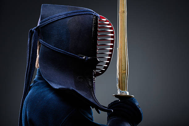 Profile of kendo fighter with shinai Profile of kendo fighter with shinai. Japanese martial art of sword fighting kendo stock pictures, royalty-free photos & images