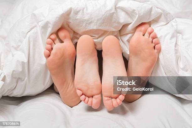 Feet In A Bed Stock Photo - Download Image Now - Adult, Adults Only, Barefoot
