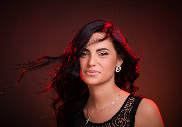 istock smiling woman with hair blowing on wind 178708958