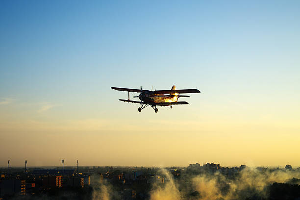 istock Silhouette of red plane flying over town 178708981