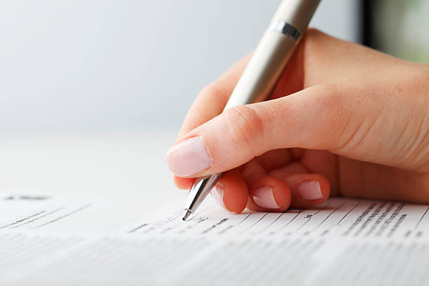istock Businesswoman writing on a form 178710120