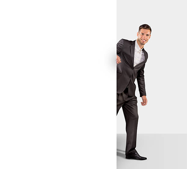 Businessman holding a large blank paper stock photo
