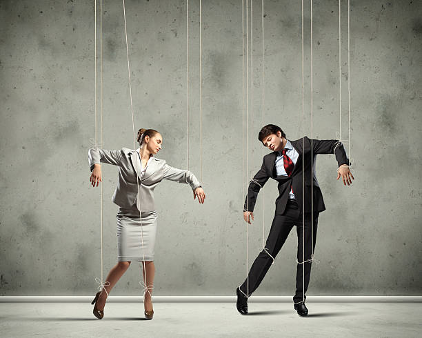 Puppet businesspeople Image of businesspeople hanging on strings like marionettes. Conceptual photography dictator photos stock pictures, royalty-free photos & images