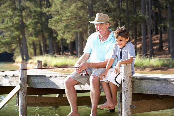 istock Senior man fishing with grandson 178710980
