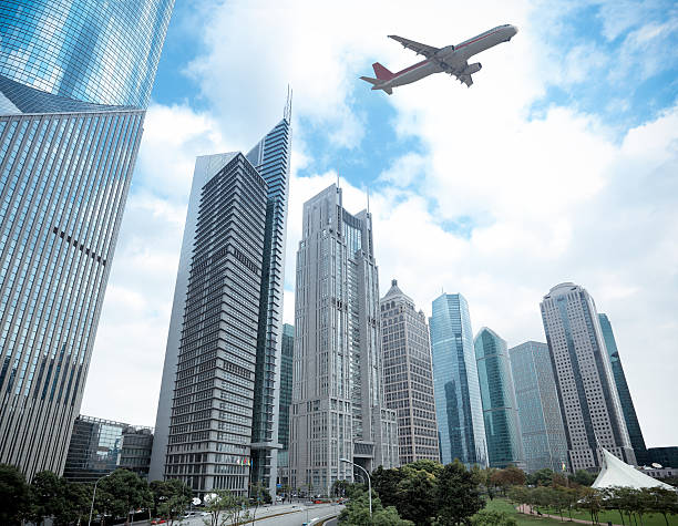 istock shanghai financial district and airplane 178711982