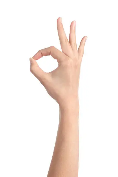 Woman hand making ok gesture isolated on a white background