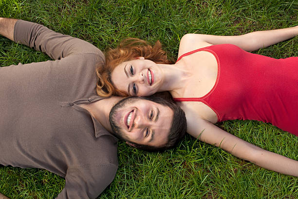 istock Happy couple in love laying down on the grass 178714473