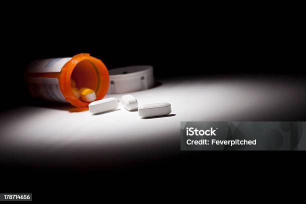 Medicine Bottle And Pills Under Spot Light Stock Photo - Download Image Now - Bottle, Capsule - Medicine, Falling