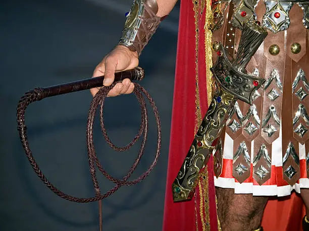 Detail of a Roman soldier carrying a gladius and whip