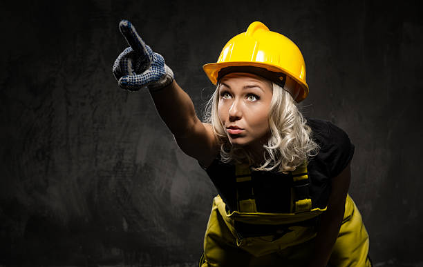 istock Attractive builder woman showing something with the hand 178714940