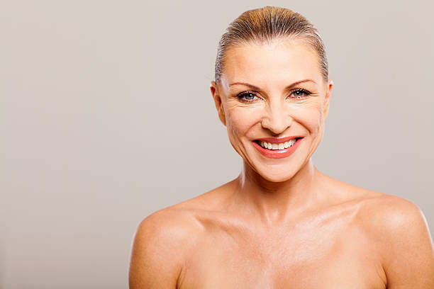 istock senior woman wearing make up 178715088