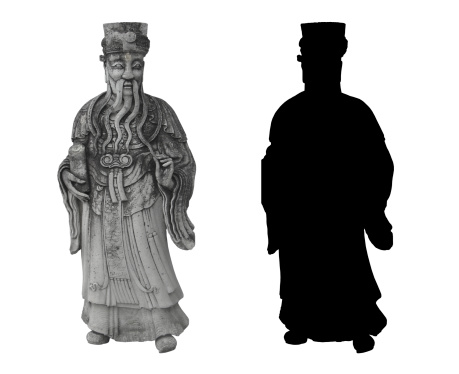 thai statue of an old noble man with a long beard and a scroll in his hand in traditional thai clothes, and his silhouette