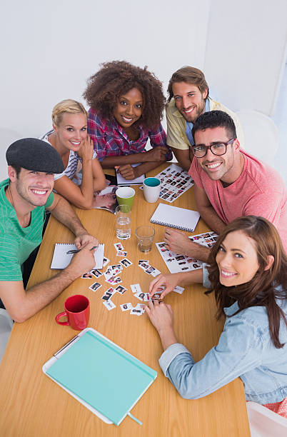 istock Editors looking up at camera in a meeting 178715512