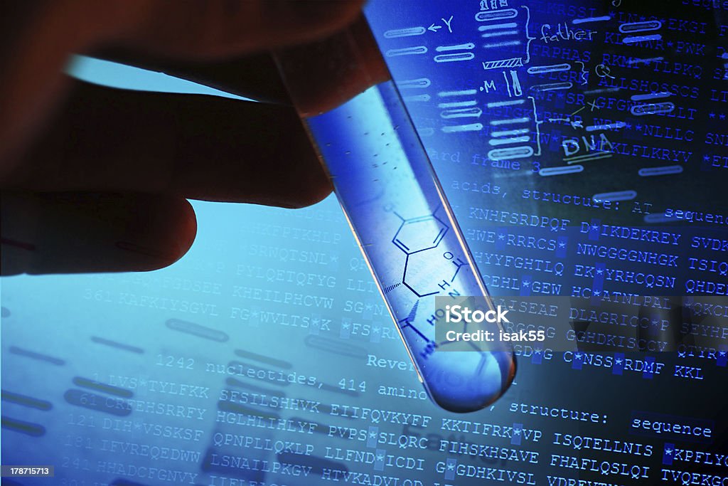 A scientist working on DNA in a test tube A test tube with blue liquid and a graphic of a partial molecule.  There is a hand holding the test tube against a computer image of sequenced DNA.  The image is highlighted in dark and light blue.  This is a macro image with selective focus. Discovery Stock Photo