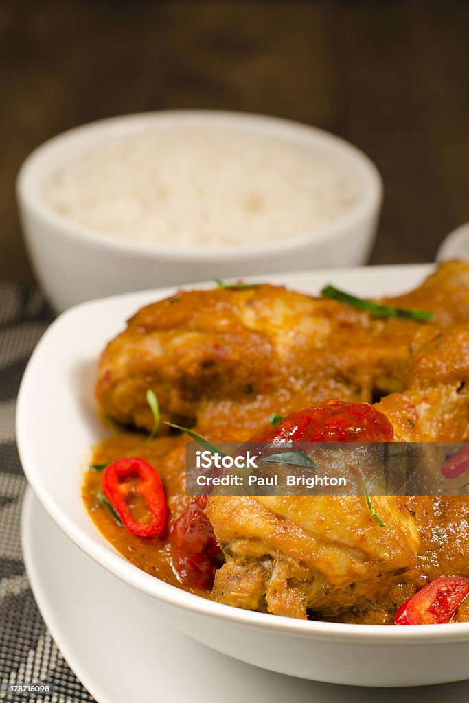 Kari Kapitan Ayam Kari Kapitan - Malaysian chicken curry with coconut milk served with rice. Traditional Nyonya cuisine. Animal Body Part Stock Photo