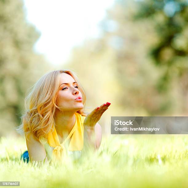 Woman Lying On Grass Stock Photo - Download Image Now - Blowing a Kiss, Lying Down, Adult