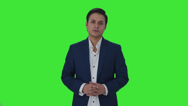 Indian journalist looking to the camera Green screen