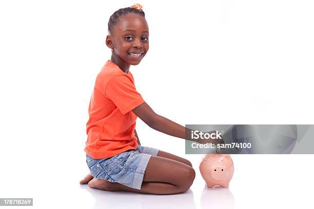 Black Girl Inserting An Euro Bill Inside A Piggy Bank Stock Photo - Download Image Now