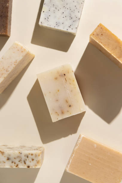 istock Natural herbal beige and brown soap bars on light beige top view, hard shadows 1787201058