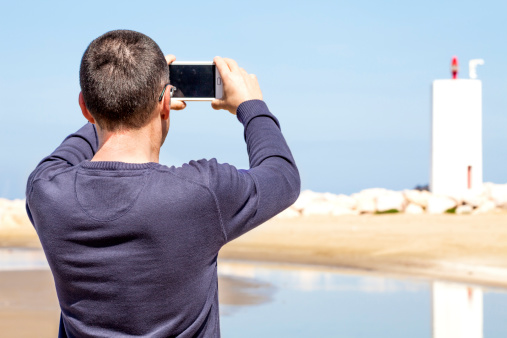 Man Photographing With Smartphone